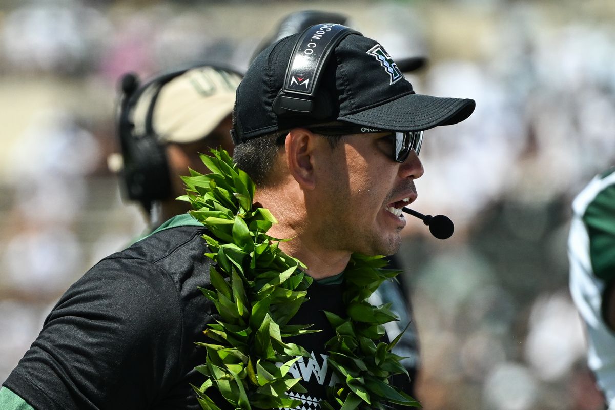 University of Hawai'i Rainbow Warriors head coach Timmy Chang prepares his offense for a drive during an NCAA football game against the Stanford Cardinal, Saturday, August 23, 2025, in Honolulu, Hawai'i.