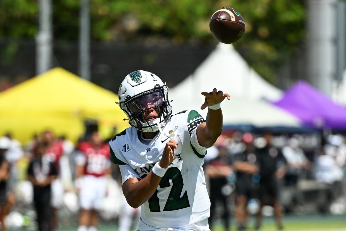 University of Hawai'i Rainbow Warriors quarterback Micah Alejado, #12, throws the Rainbow Warriors' first touchdown of the game during an NCAA football game against the Stanford Cardinal, Saturday, August 23, 2025, in Honolulu, Hawai'i.