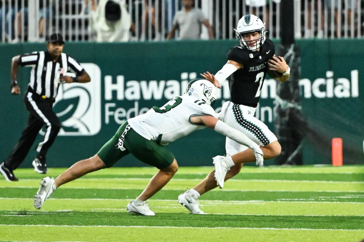 University of Hawai'i Rainbow Warriors quarterback Luke Weaver (2) stiff arms Portland State Vikings defensive back Pierce Walker (3) during an NCAA football game against the Portland State Vikings, Saturday, September 13, 2025, in Honolulu, Hawai'i.