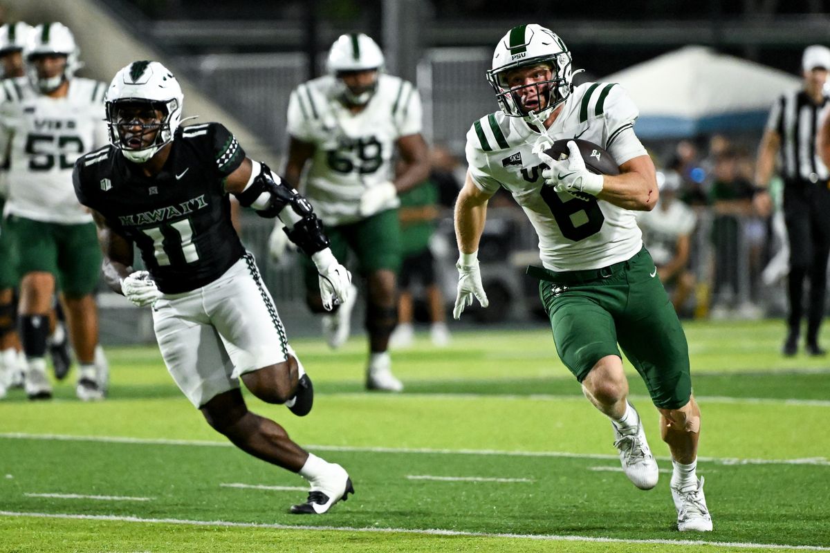 Portland State Vikings quarterback Cru Newman (6) is chased down by University of Hawai'i Rainbow Warriors linebacker Jamih Otis (11) during an NCAA football game against the University of Hawai'i Rainbow Warriors, Saturday, September 13, 2025, in Honolulu, Hawai'i.