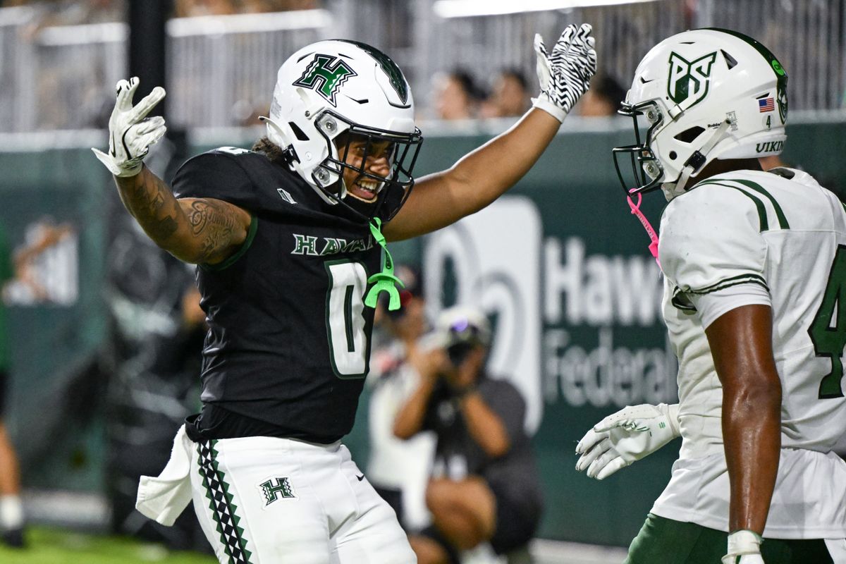 University of Hawai'i Rainbow Warriors running back Cam Barfield (0) celebrates in Portland State Vikings defensive back Isaiah Green's (4) face during an NCAA football game, Saturday, September 13, 2025, in Honolulu, Hawai'i.