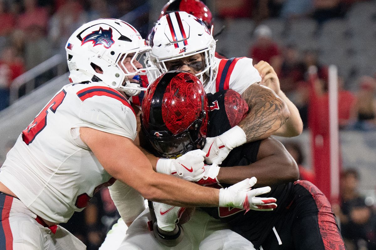 San Diego State University wide receiver Jordan Napier (2) gets tackled during an NCAA football game against Stony Brook University, Thursday August 28, 2025 in San Diego, California.
