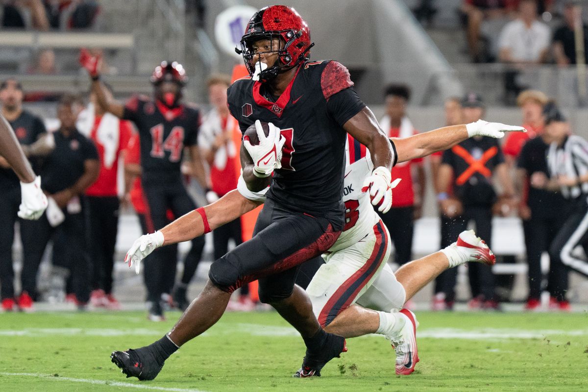 San Diego State University running back Lucky Sutton (7) runs up the field during an NCAA football game against Stony Brook University, Thursday August 28, 2025 in San Diego, California.