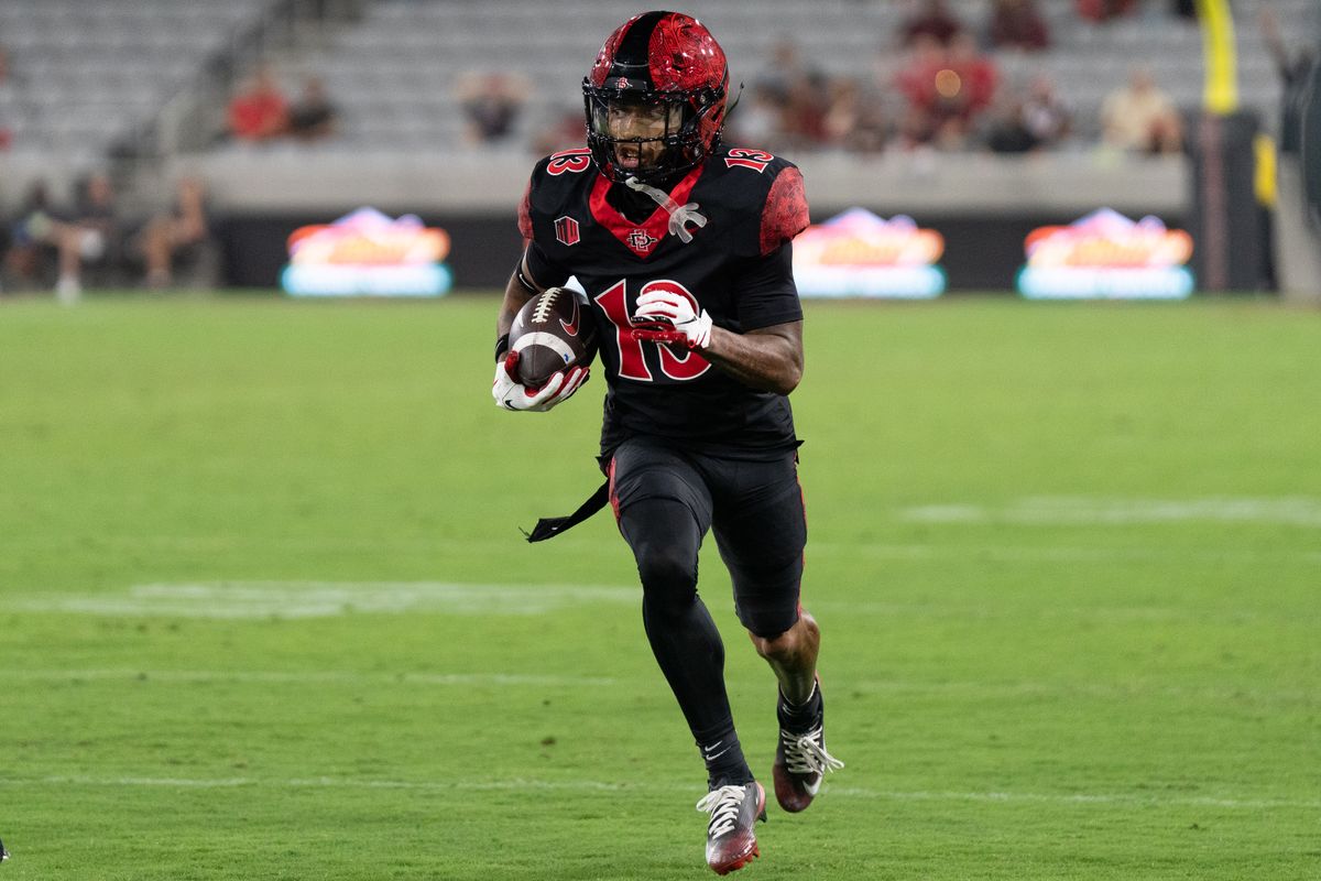San Diego State University wide receiver Nathan Acevedo (13) runs up the field during an NCAA football game against Stony Brook University, Thursday August 28, 2025 in San Diego, California.