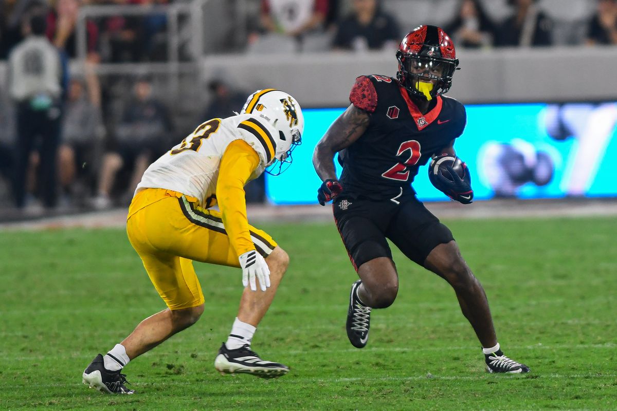 SDSU wide receiver Jordan Napier (2) maneuvers past Wyoming safety Jones Thomas (23) during an NCAA football game against the Wyoming Cowboys Saturday November 1, 2025 in San Diego, California. SDSU wide receiver Jordan Napier (2) maneuvers past Wyoming safety Jones Thomas (23) during an NCAA football game against the Wyoming Cowboys Saturday November 1, 2025 in San Diego, California.
