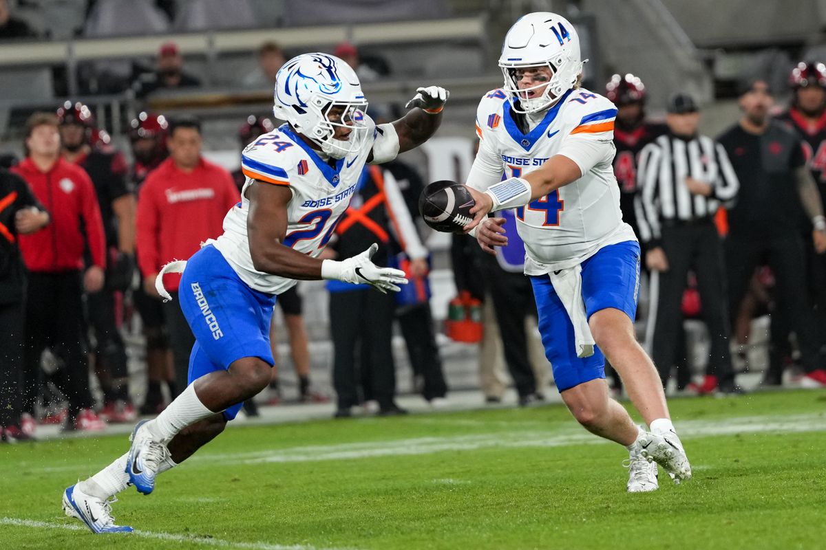 Boise State quarterback Max Cutforth (14) hands the ball to Boise State running back Dylan Riley (24) during an NCAA football game against SDSU, Saturday November 15, 2025 in San Diego, California.
