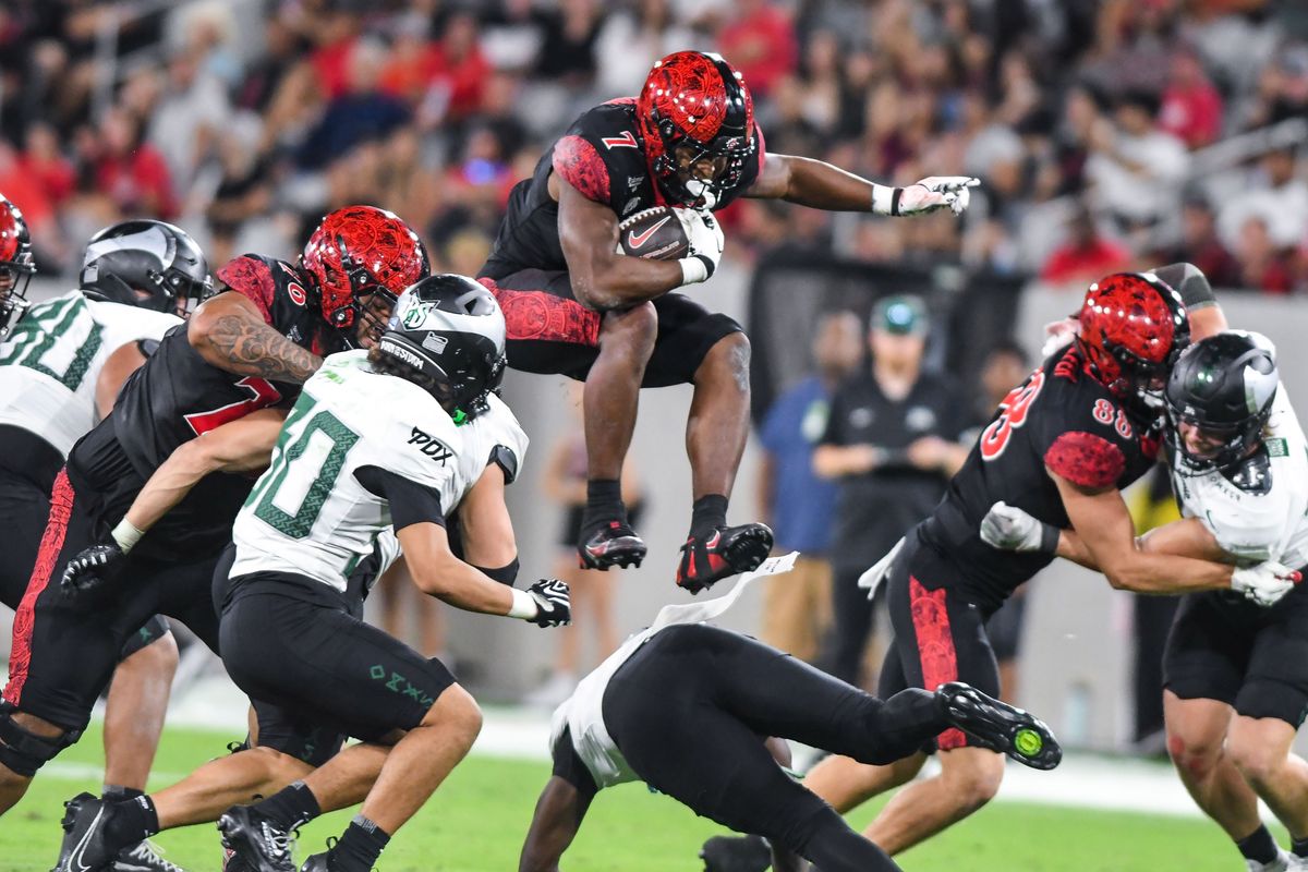 SDSU  running back Lucky Sutton (7&nbsp;) hurdles a defender during an NCAA football  game against Portland State Saturday September 5, 2026 in  San Diego, Calif..