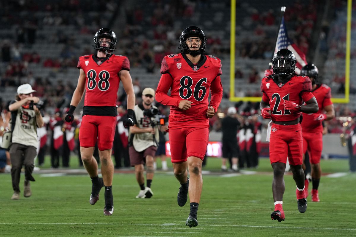 San Diego State University placekicker Noah Serna (86) and teammates runs onto the field before an NCAA football game against James Madison University, Saturday September 19, 2026 in San Diego, California.