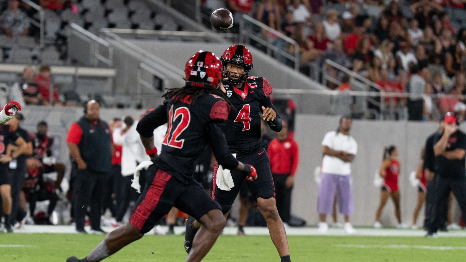 San Diego State University quarterback Jayden Denegal (4) throws the ball to San Diego State University wide receiver Jaylon Hawkins (12) during a PAC-12 football game against Fresno State, Saturday October 17, 2026 in San Diego, California. San Diego State University quarterback Jayden Denegal (4) throws the ball to San Diego State University wide receiver Jaylon Hawkins (12) during a PAC-12 football game against Fresno State, Saturday October 17, 2026 in San Diego, California.