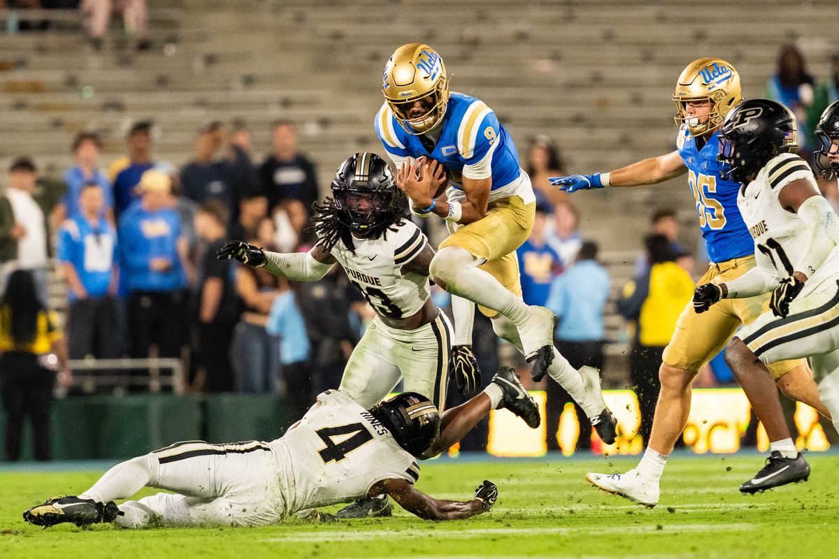 UCLA Bruins QB Nico Iamaleava (9) attempts to jump over the defense during a NCAA football game against Purdue at Rose Bowl Stadium on September 19th, 2026 in Pasadena, California. UCLA Bruins QB Nico Iamaleava (9) attempts to jump over the defense during a NCAA football game against Purdue at Rose Bowl Stadium on September 19th, 2026 in Pasadena, California.