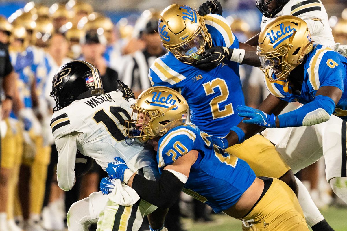 UCLA Bruins defense swarms the other team during a NCAA football game against Purdue at Rose Bowl Stadium on September 19th, 2026 in Pasadena, California. UCLA Bruins defense swarms the other team during a NCAA football game against Purdue at Rose Bowl Stadium on September 19th, 2026 in Pasadena, California.