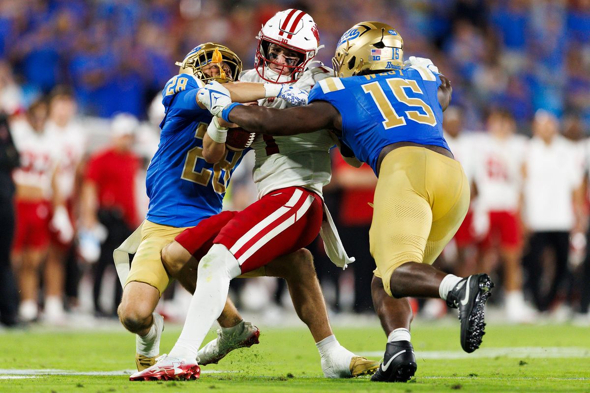 Mason Rivera #28 of the UCLA Bruins and Sahir West #15 of the UCLA Bruins sack Colton Joseph #1 of the Wisconsin Badgers during the game at Rose Bowl Stadium on October 17, 2026 in Pasadena, California. Mason Rivera #28 of the UCLA Bruins and Sahir West #15 of the UCLA Bruins sack Colton Joseph #1 of the Wisconsin Badgers during the game at Rose Bowl Stadium on October 17, 2026 in Pasadena, California.