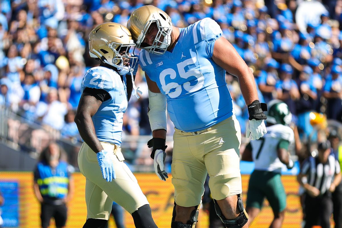 Javian Thomas #21 and Hall Schmidt #65 of the UCLA Bruins celebrate a touchdown during the game against the Michigan State Spartans at Rose Bowl Stadium on October 24, 2026 in Pasadena, California. Javian Thomas #21 and Hall Schmidt #65 of the UCLA Bruins celebrate a touchdown during the game against the Michigan State Spartans at Rose Bowl Stadium on October 24, 2026 in Pasadena, California.