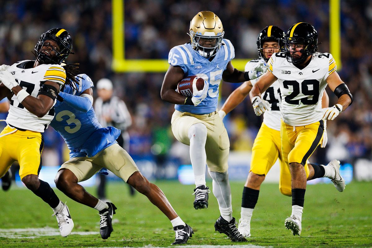 T.J. Harden #25 of the UCLA Bruins runs with the ball during the first half game against Iowa Hawkeyes at Rose Bowl Stadium on November 8, 2024 in Pasadena, California.