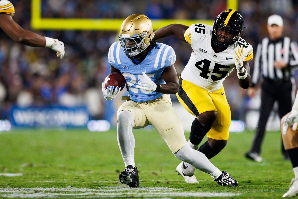 T.J. Harden #25 of the UCLA Bruins runs with the ball during the first half game against Iowa Hawkeyes at Rose Bowl Stadium on November 8, 2024 in Pasadena, California. 