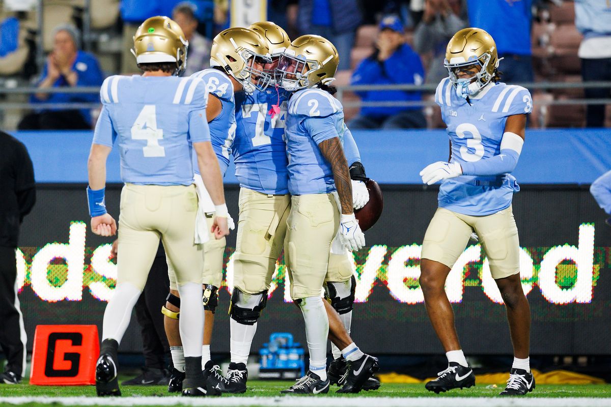 Titus Mokiao-Atimalala #2 of the UCLA Bruins celebrates during the first half game against Iowa Hawkeyes at Rose Bowl Stadium on November 8, 2024 in Pasadena, California.