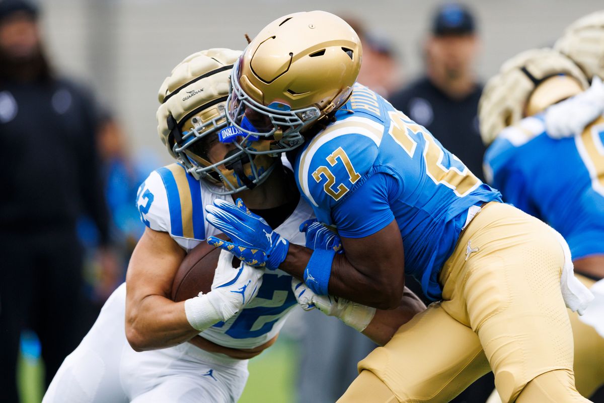 Troy Leigber #32 is tackled by Jadyn Hudson #27 during the UCLA Football Spring Showcase at Rose Bowl Stadium on May 3, 2025 in Pasadena, California.