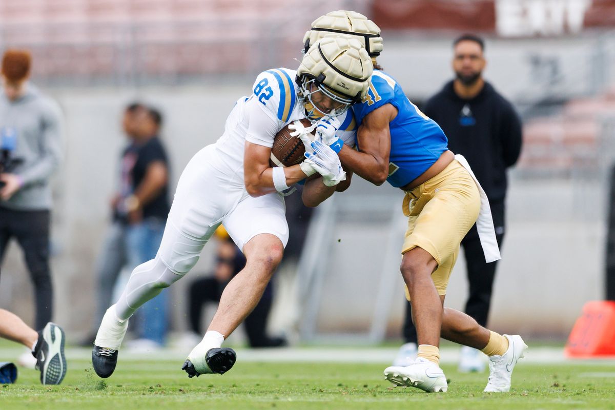 Noah Flores #82 is tackled by JuJu Walls #41 during the UCLA Football Spring Showcase at Rose Bowl Stadium on May 3, 2025 in Pasadena, California.