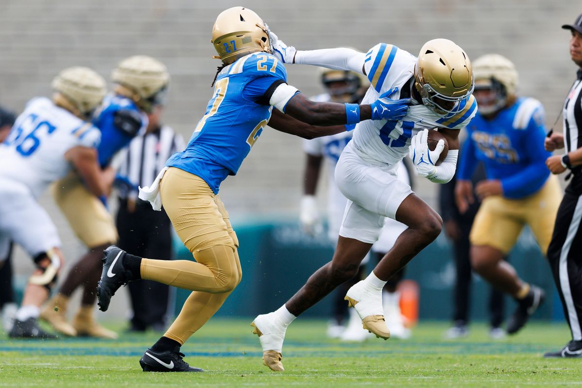 Jaedon Wilson #11 straight arms Jadyn Hudson #27 during the UCLA Football Spring Showcase at Rose Bowl Stadium on May 3, 2025 in Pasadena, California.