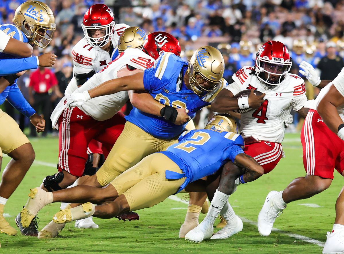 #2 Andre Jordan Jr. of the UCLA Bruins makes a tackle on #4 Devon Dampier of the Utah Utes during an NCAA football game, Saturday August 30, 2025 in Pasadena, CA. #2 Andre Jordan Jr. of the UCLA Bruins makes a tackle on #4 Devon Dampier of the Utah Utes during an NCAA football game, Saturday August 30, 2025 in Pasadena, CA.