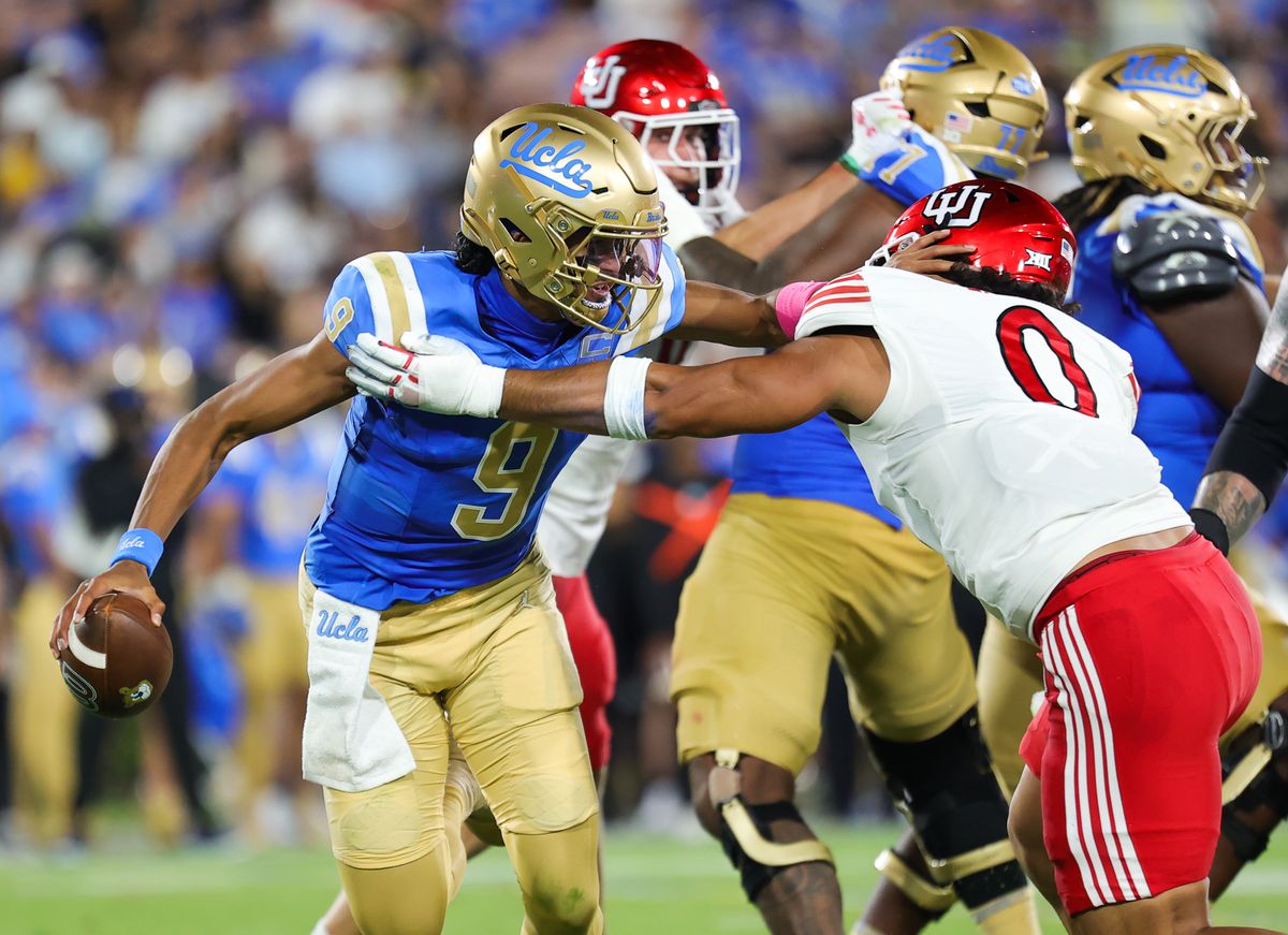 #9 Nico Iamaleava of the UCLA Bruins tries to evade #0 Logan Fano of the Utah Utes during an NCAA game, August 30, 2025 in Pasadena, CA. #9 Nico Iamaleava of the UCLA Bruins tries to evade #0 Logan Fano of the Utah Utes during an NCAA game, August 30, 2025 in Pasadena, CA.