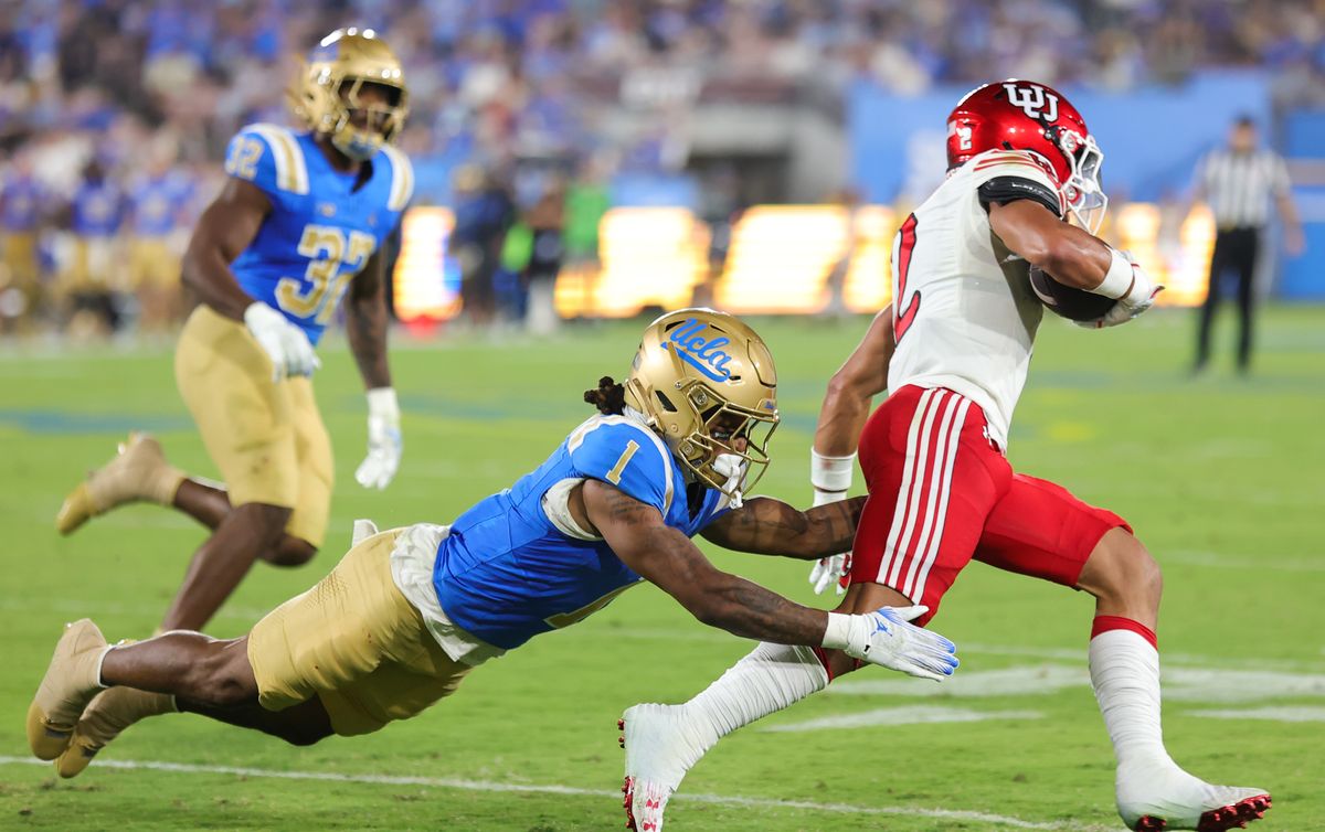 #1 Donavyn Pellot of the UCLA Bruins attempts to tackle #2 Creed Whittemore of the Utah Utes during an NCAA football game, August 30, 2025 in Pasadena, CA. #1 Donavyn Pellot of the UCLA Bruins attempts to tackle #2 Creed Whittemore of the Utah Utes during an NCAA football game, August 30, 2025 in Pasadena, CA.