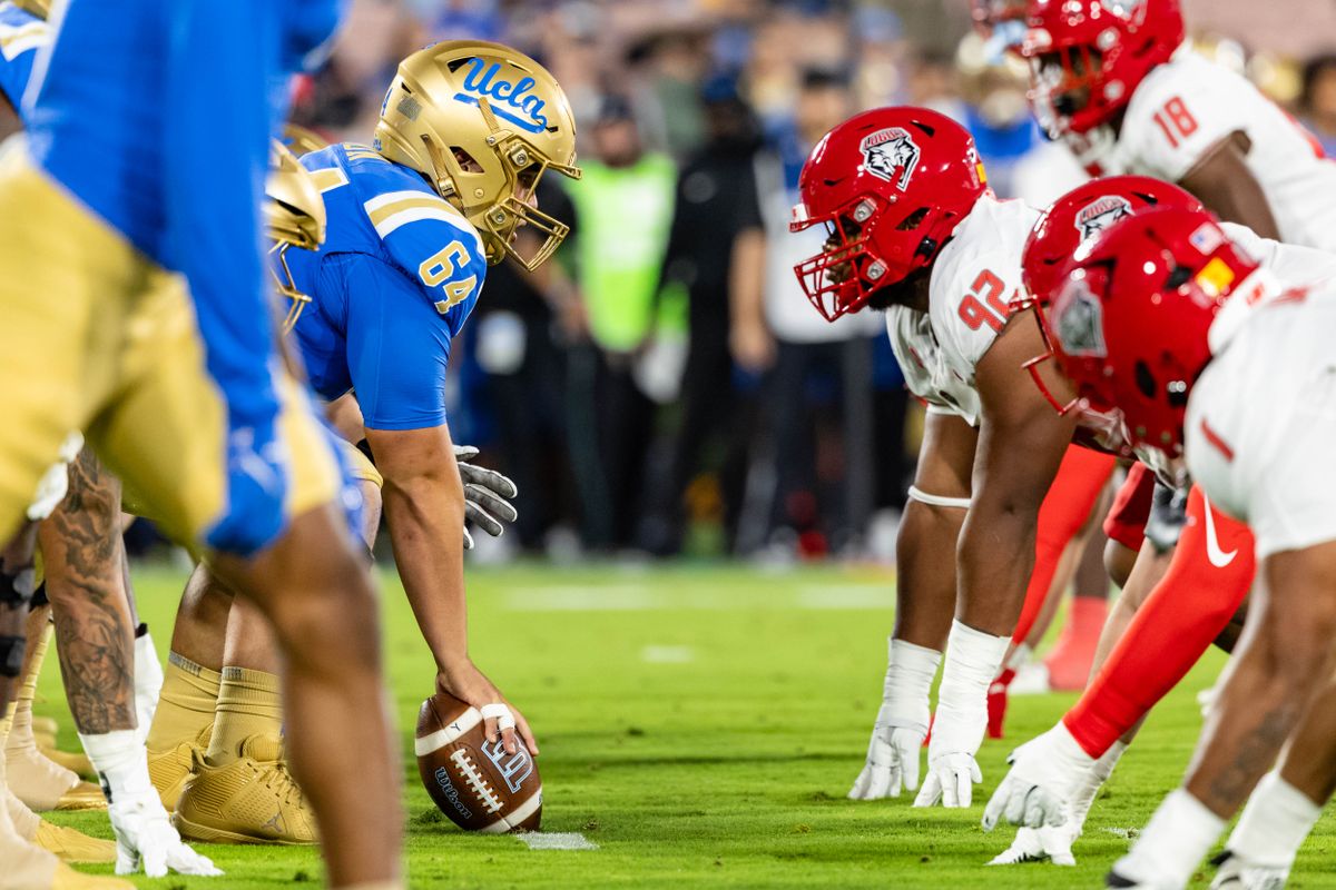 Offensive lineman Sam Yoon #64 of the UCLA Bruins prepares to snap the ball during an NCAA football game agains the New Mexico Lobos at the Rose Bowl on September 12, 2025 in Pasadena, California. Offensive lineman Sam Yoon #64 of the UCLA Bruins prepares to snap the ball during an NCAA football game agains the New Mexico Lobos at the Rose Bowl on September 12, 2025 in Pasadena, California.