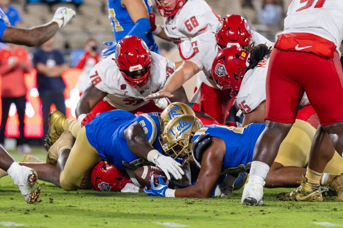 Defensive lineman Gary Smith III #58 of the UCLA Bruins and defensive lineman Devin Aupiu #44 of the UCLA Bruins reach for a fumble during an NCAA football game against the New Mexico Lobos at the Rose Bowl on September 12, 2025 in Pasadena, California. Defensive lineman Gary Smith III #58 of the UCLA Bruins and defensive lineman Devin Aupiu #44 of the UCLA Bruins reach for a fumble during an NCAA football game against the New Mexico Lobos at the Rose Bowl on September 12, 2025 in Pasadena, California.