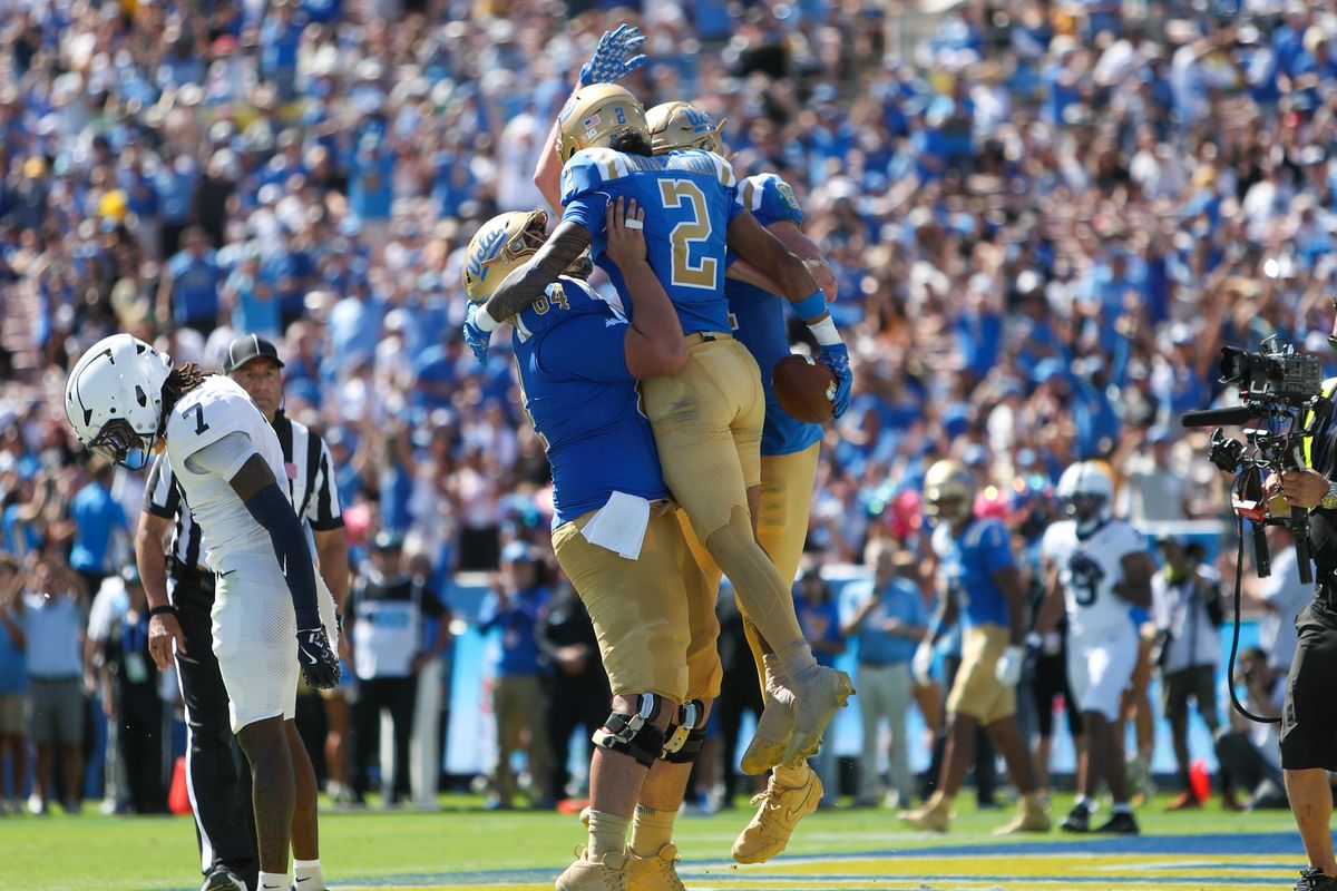 #2 Titus Mokiao-Atimalala of UCLA celebrates a touchdown with teammates during an NCAA football game against Penn State on October 4, 2025 in Pasadena, CA. #2 Titus Mokiao-Atimalala of UCLA celebrates a touchdown with teammates during an NCAA football game against Penn State on October 4, 2025 in Pasadena, CA.