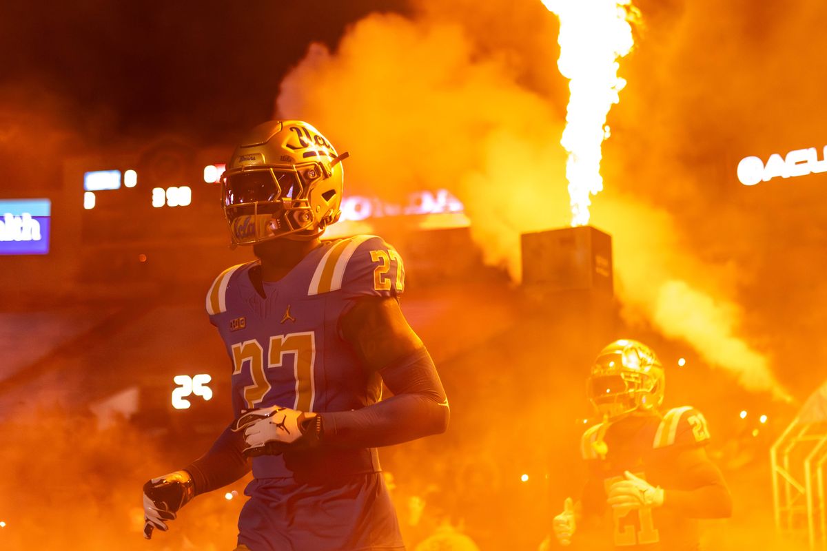 UCLA Bruins running back Isaiah Carlson (27) runs out of the smoke before the game against Nebraska Cornhuskers at Rose Bowl Stadium on November 8, 2025 in Pasadena, California. 
