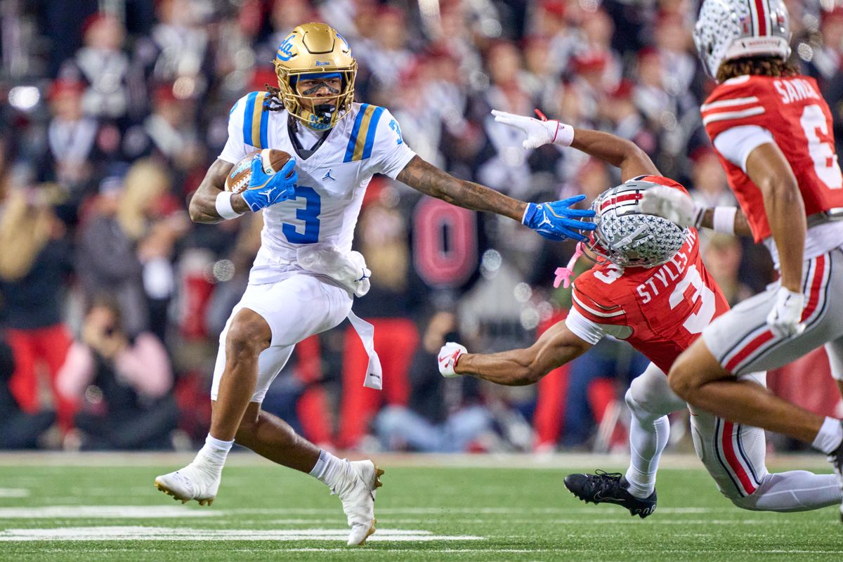 UCLA Bruins wide receiver Kwazi Gilmer #3 runs with the football past Ohio State Buckeyes cornerback Lorenzo Styles Jr. #3 in the second half against the Ohio State Buckeyes during a college football game at Ohio Stadium on November 15, 2025 in Columbus, Ohio. UCLA Bruins wide receiver Kwazi Gilmer #3 runs with the football past Ohio State Buckeyes cornerback Lorenzo Styles Jr. #3 in the second half against the Ohio State Buckeyes during a college football game at Ohio Stadium on November 15, 2025 in Columbus, Ohio.