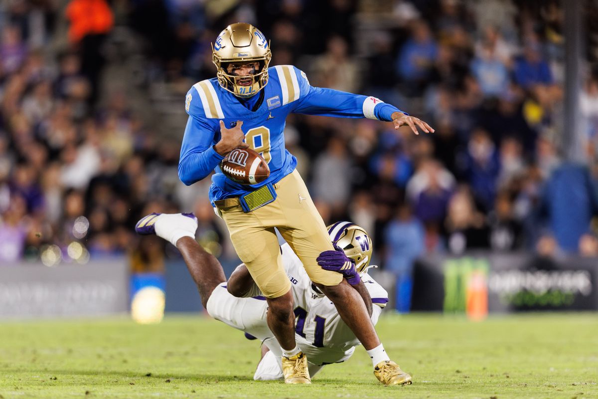 UCLA Bruins quarterback Nico Iamaleava (9) gets dived while running the ball during the game against Washington Huskies at Rose Bowl Stadium on November 22, 2025 in Pasadena, California. 