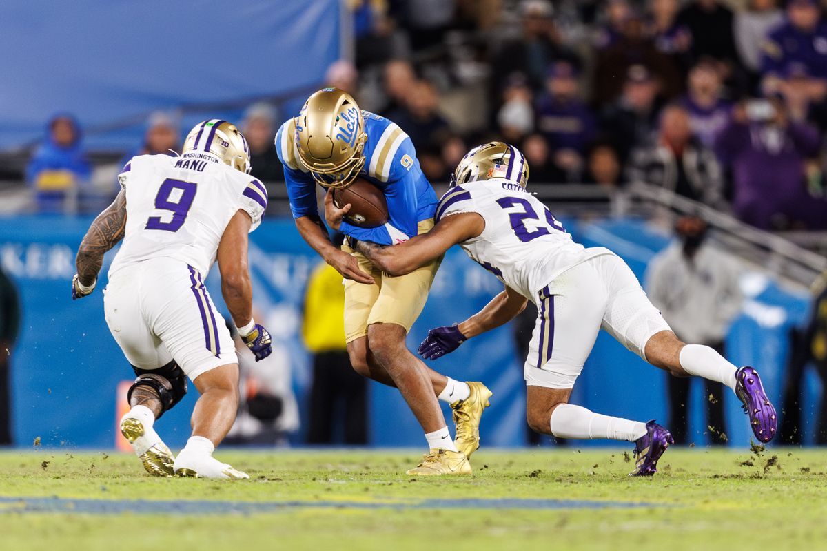 UCLA Bruins quarterback Nico Iamaleava (9) gets tackled during the game against Washington Huskies at Rose Bowl Stadium on November 22, 2025 in Pasadena, California. 