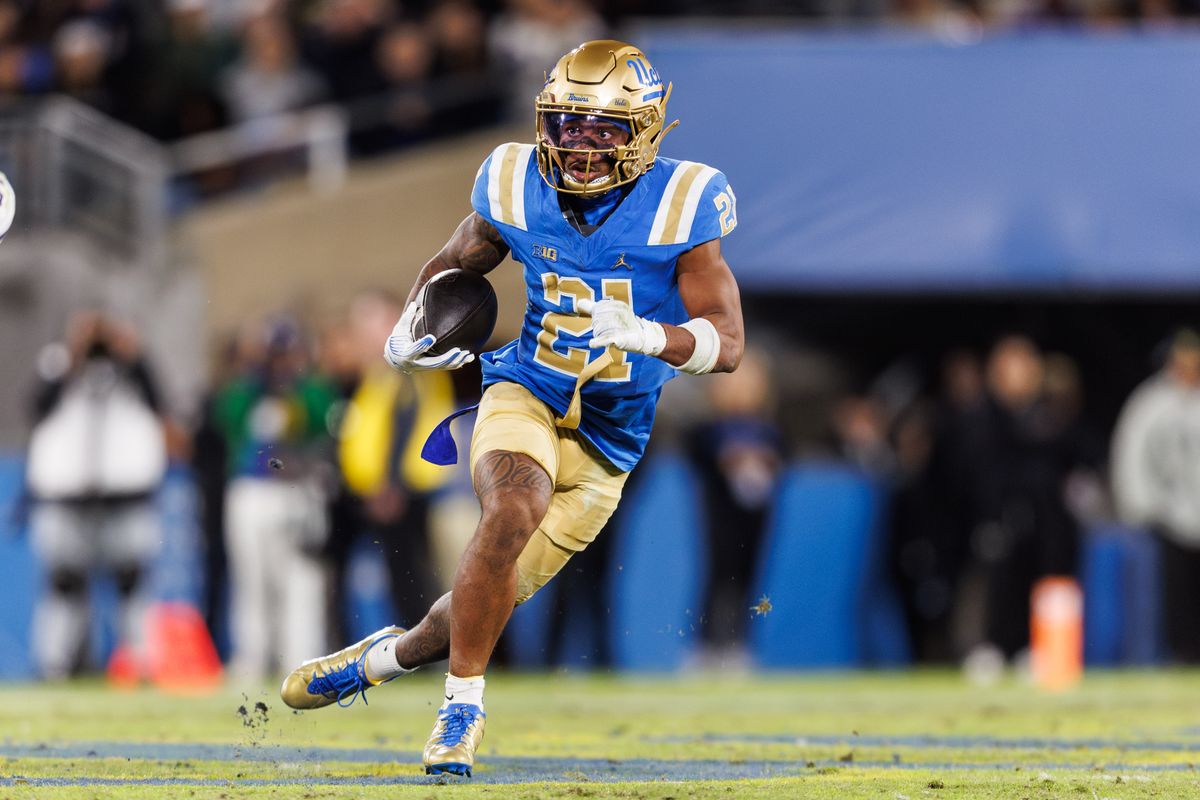 UCLA Bruins defensive back Cole Martin (21) intercepts the ball during the game against Washington Huskies at Rose Bowl Stadium on November 22, 2025 in Pasadena, California. 