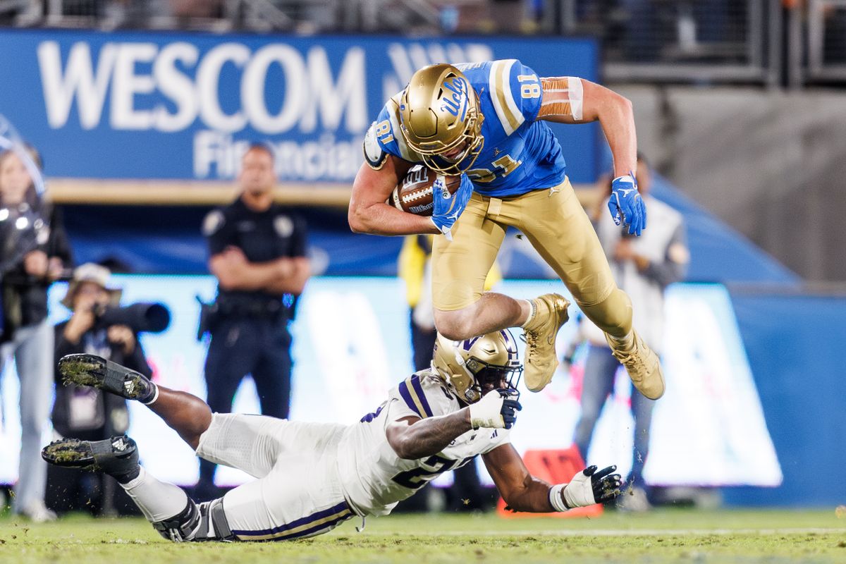 UCLA Bruins tight end Hudson Habermehl (81) attempts to hurdle while running the ball during the game against Washington Huskies at Rose Bowl Stadium on November 22, 2025 in Pasadena, California. 