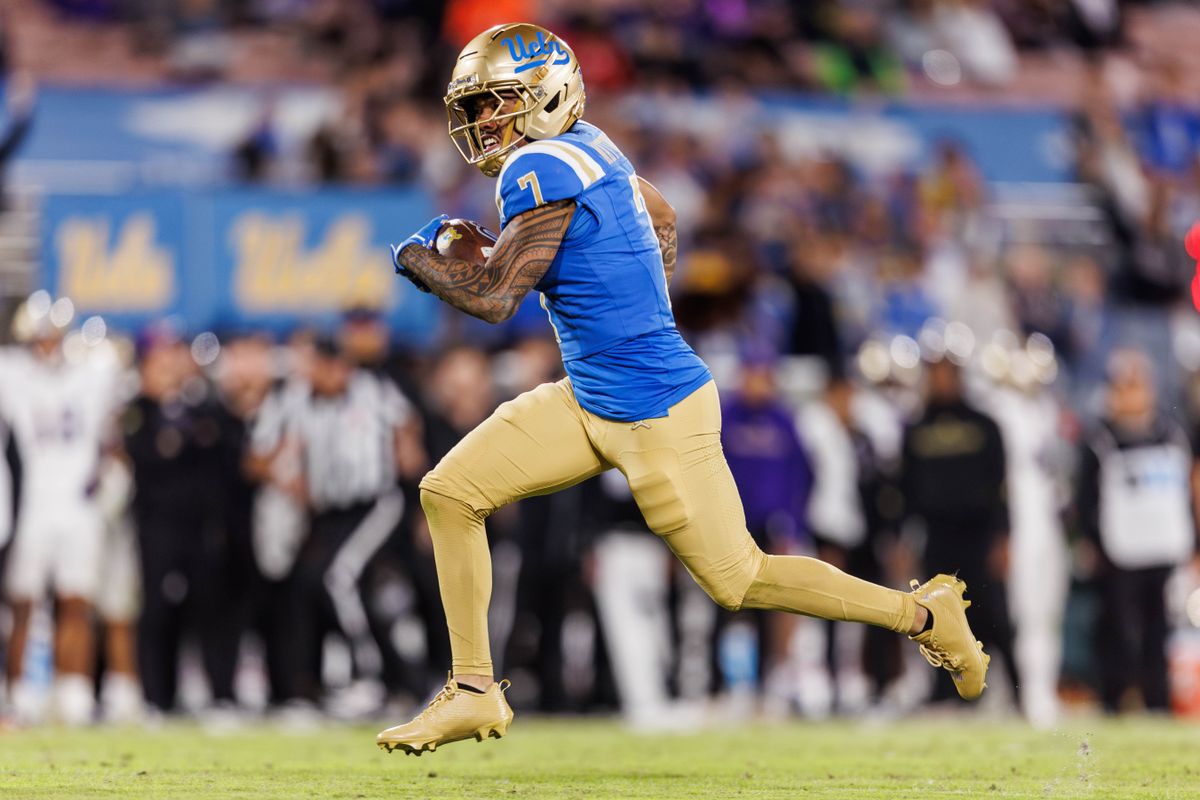 UCLA Bruins wide receiver Mikey Matthews (7) runs ball in for a touchdown during the game against Washington Huskies at Rose Bowl Stadium on November 22, 2025 in Pasadena, California. 