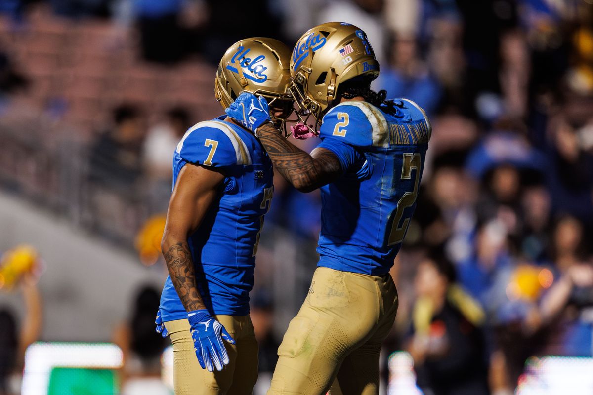 UCLA Bruins wide receiver Mikey Matthews (7) celebrates touchdown with UCLA Bruins wide receiver Titus Mokiao-Atimalala (2) during the game against Washington Huskies at Rose Bowl Stadium on November 22, 2025 in Pasadena, California. 
