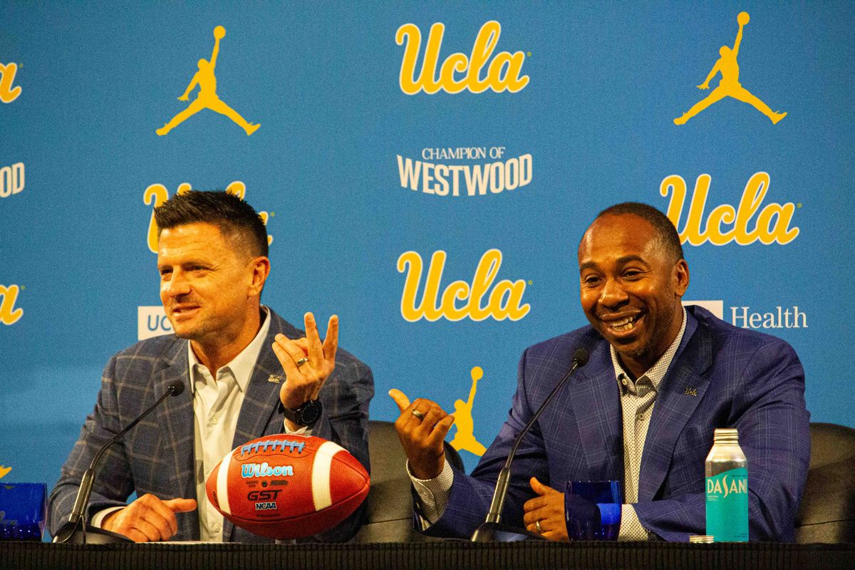 UCLA athletic director Martin Jarmond gestures toward new football head coach Bob Chesney at the introductory press conference for Bob Chesney at Luskin Conference Center Tuesday, December 9, 2025 in Los Angeles.