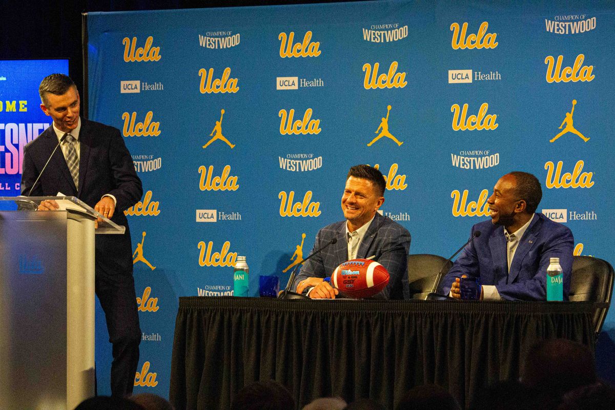 New UCLA football head coach Bob Chesney, athletic director Martin Jarmond and Nick Koop, the host of the event and host of the Bruin Insider Show, at the introductory press conference for Bob Chesney at Luskin Conference Center Tuesday, December 9, 2025 in Los Angeles. 