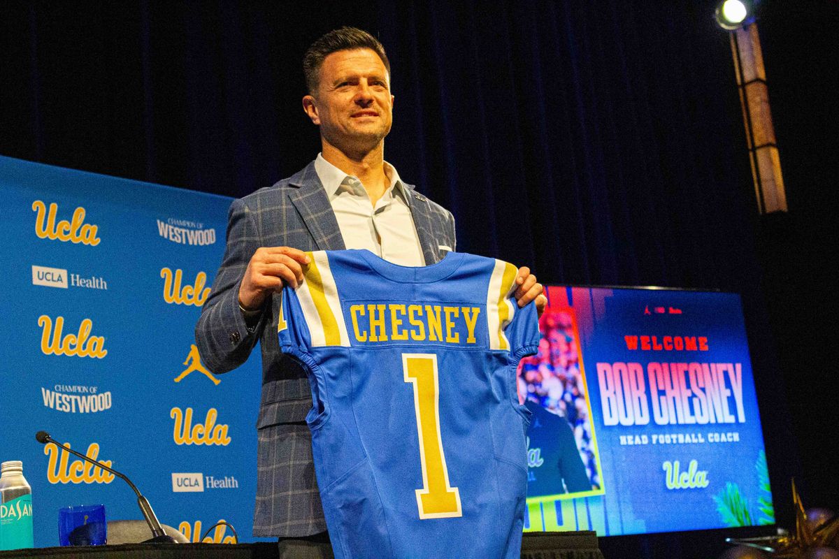 New UCLA football head coach Bob Chesney poses with his new jersey at the introductory press conference for Bob Chesney at Luskin Conference Center Tuesday, December 9, 2025 in Los Angeles. 
