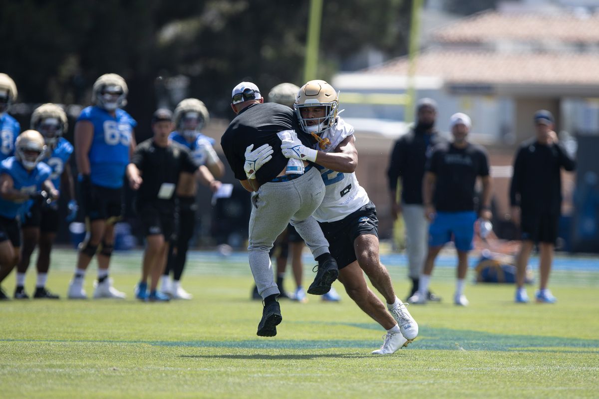UCLA coaches get involved in player drills during football practice at the Wasserman Football Center in Los Angeles, CA on Aug. 7, 2026. UCLA coaches get involved in player drills during football practice at the Wasserman Football Center in Los Angeles, CA on Aug. 7, 2026.