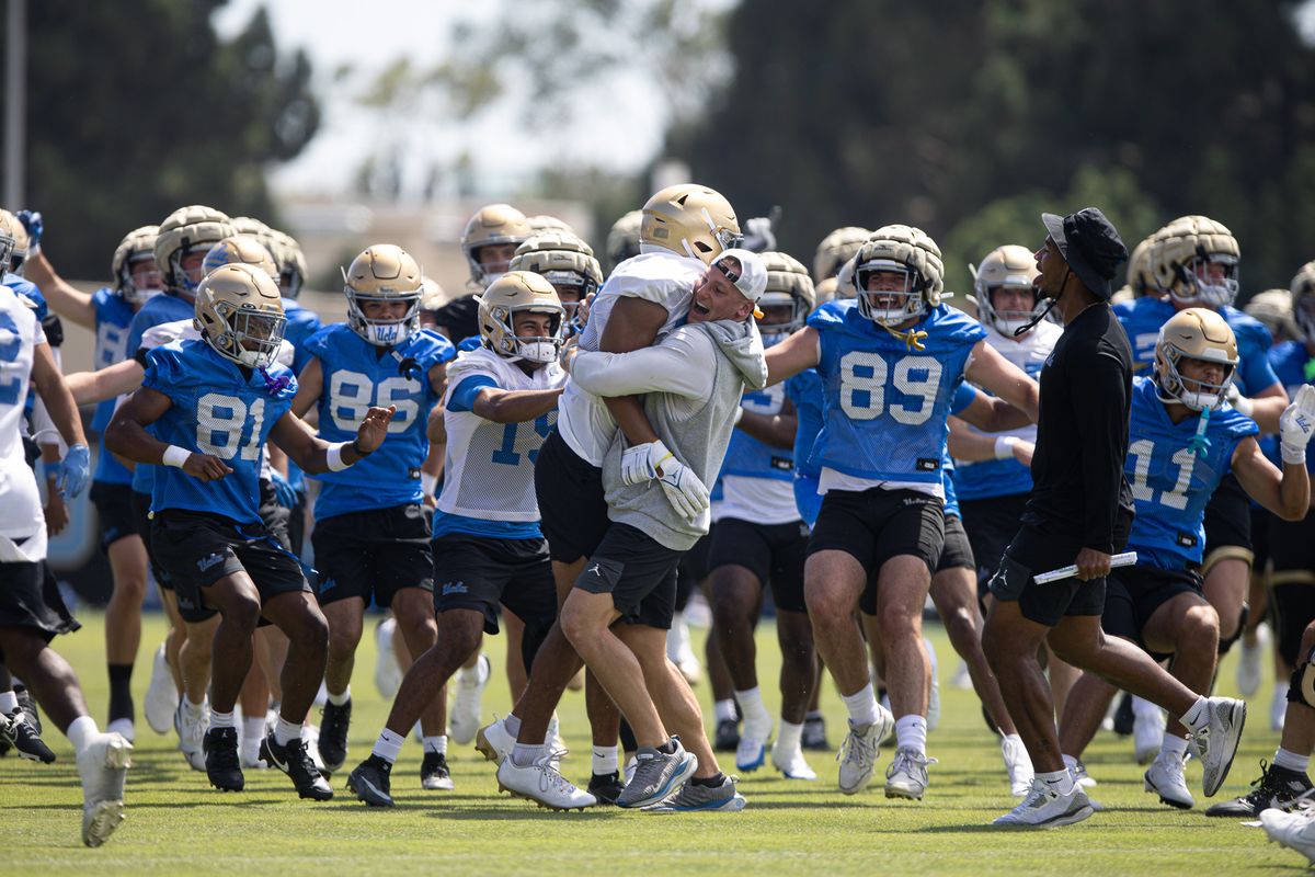 UCLA players and coaches celebrate a successful drill during practice on Friday, Aug. 7, 2026, at Wasserman Football Center in Los Angeles, CA. UCLA players and coaches celebrate a successful drill during practice on Friday, Aug. 7, 2026, at Wasserman Football Center in Los Angeles, CA.