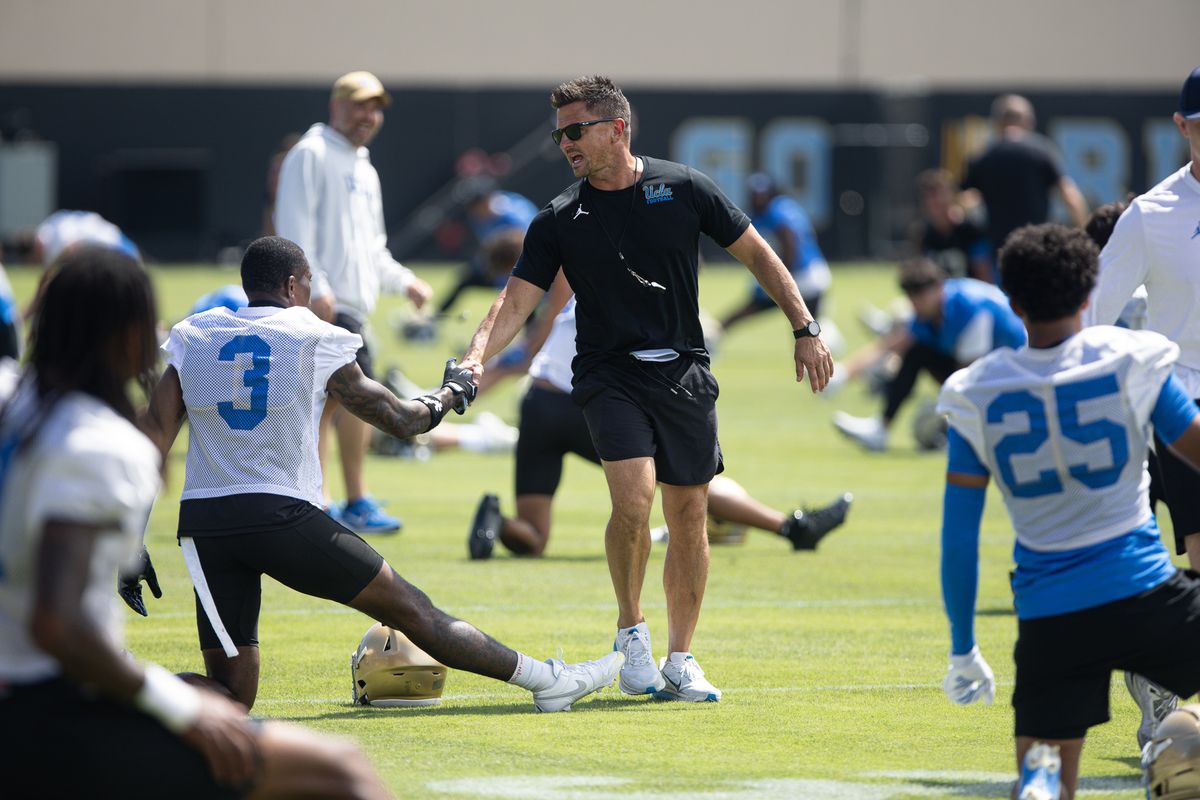 UCLA head coach Bob Chesney greets players during stretches at the beginning of practice on Friday, Aug. 7, 2026, in Los Angeles, CA. UCLA head coach Bob Chesney greets players during stretches at the beginning of practice on Friday, Aug. 7, 2026, in Los Angeles, CA.