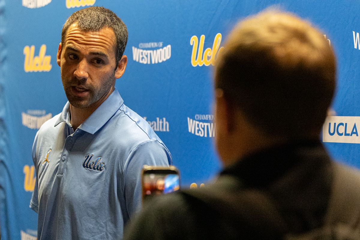 UCLA offensive coordinator Dean Kennedy answers questions from media during media day at Pavilion Club in Pauley Pavilion, Los Angeles. UCLA offensive coordinator Dean Kennedy answers questions from media during media day at Pavilion Club in Pauley Pavilion, Los Angeles.