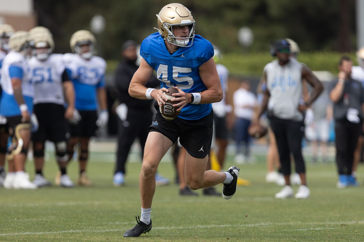 UCLA punter Chase Barry (45) takes the ball during a fake field goal during practice at Wasserman Football Center, Thursday, Aug. 27, 2026, in Los Angeles.