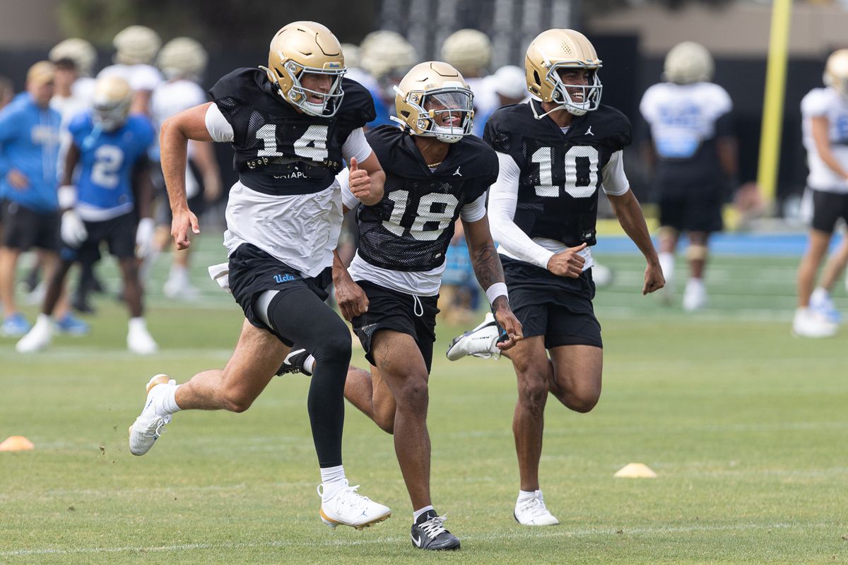 UCLA quarterbacks sprint during practice at Wasserman Football Center, Thursday, Aug. 27, 2026, in Los Angeles.