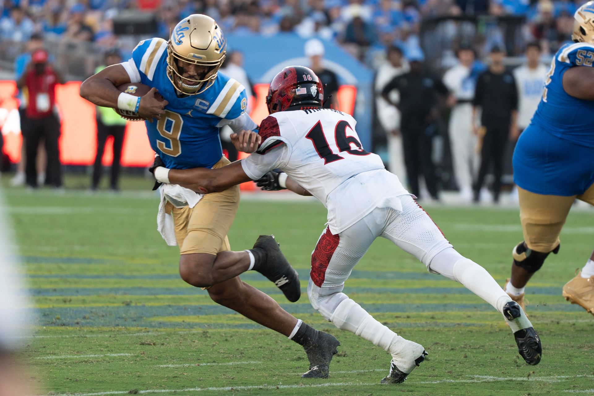UCLA Bruins QB Nico Iamaleava (9) avoids the defender on his way to a first down during a game against San Diego State Aztecs at Rose Bowl Stadium on September 12, 2026 in Pasadena, California. UCLA Bruins QB Nico Iamaleava (9) avoids the defender on his way to a first down during a game against San Diego State Aztecs at Rose Bowl Stadium on September 12, 2026 in Pasadena, California.
