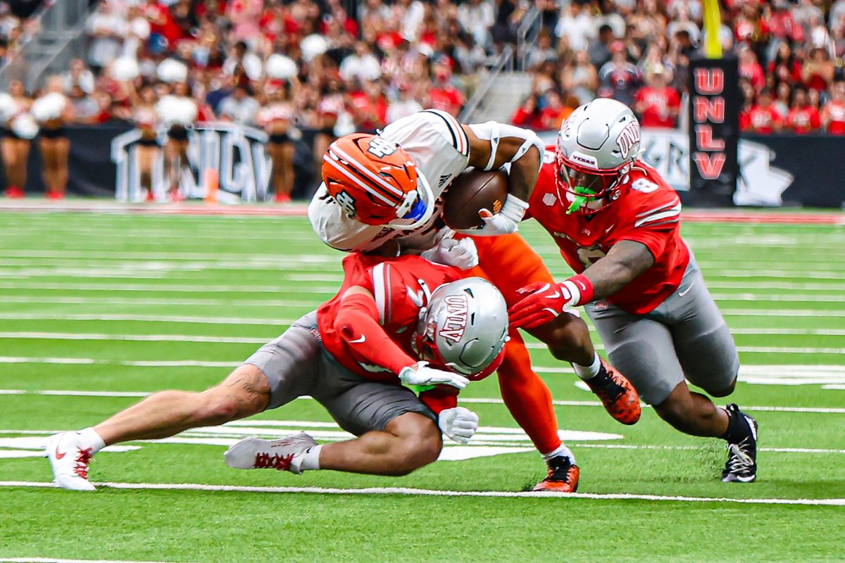 UNLV Rebels S Jake Pope (7) and ILB Marsel McDuffie (8) tackle an Idaho State Bengals player during a college football game on Saturday August 23, 2025, in Las Vegas, Nevada. 
