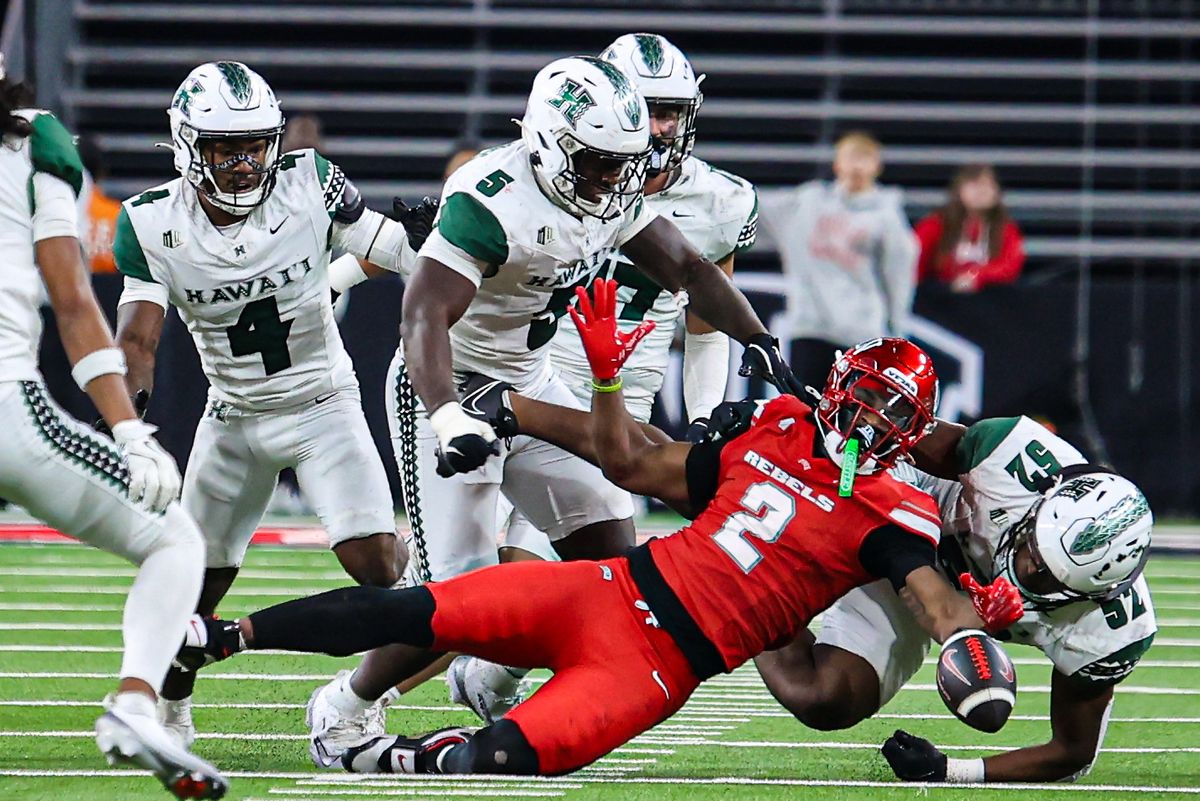 UNLV Rebels RB Keyvone Lee (2) loses possession of the ball after being tackled by several Hawai'i Rainbow Warriors players during a college football game on Friday November 21, 2025, in Las Vegas, Nevada. 