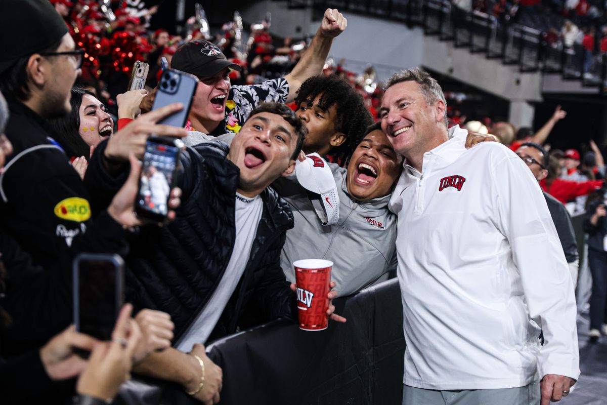 UNLV Rebels HC Dan Mullen poses with UNLV students after defeating the Hawai'i Rainbow Warriors in the 9th Island Showdown on Friday November 21, 2025, in Las Vegas, Nevada. 